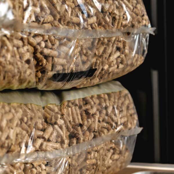 stack-pellet-bags-renewable-energy-compressed-wood-alternative-lifestyle